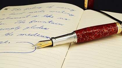 a fountain pen in a notebook.