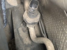 I took the sensor out to inspect it more but I also noticed that this metal pipe it’s attached to go to the front of the car near the fan and has a cap I can twist off (circled in next picture)