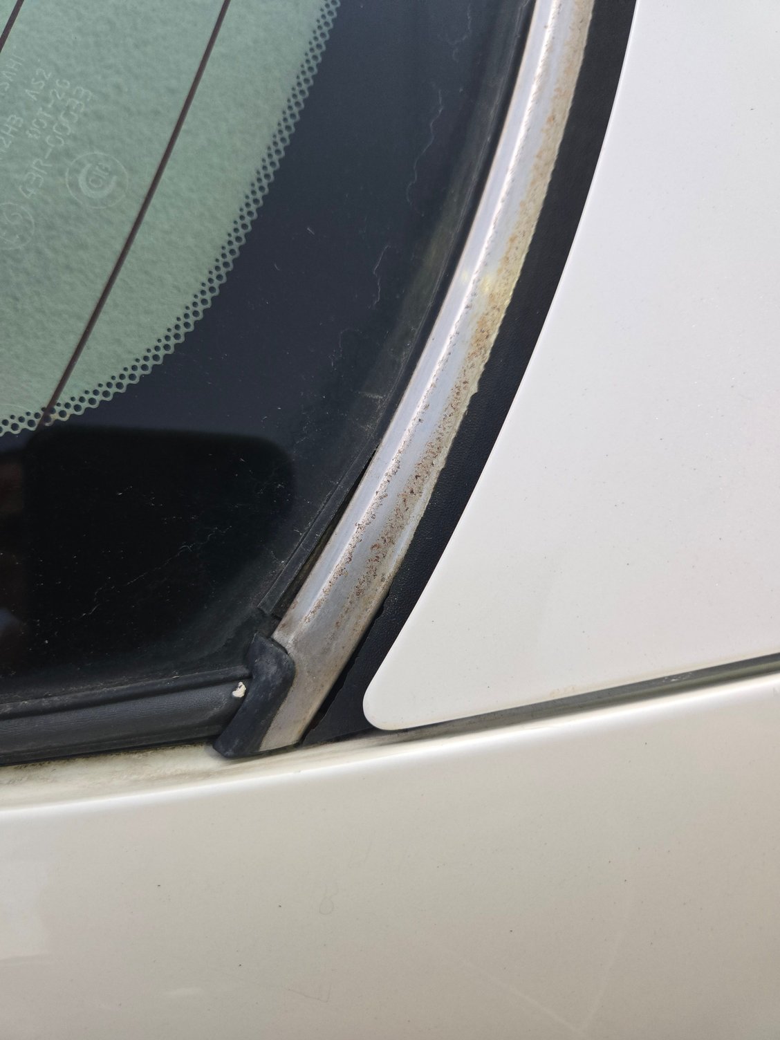 if you look closely, the rubber-metal-rubber at the bottom of the windshield is separated.