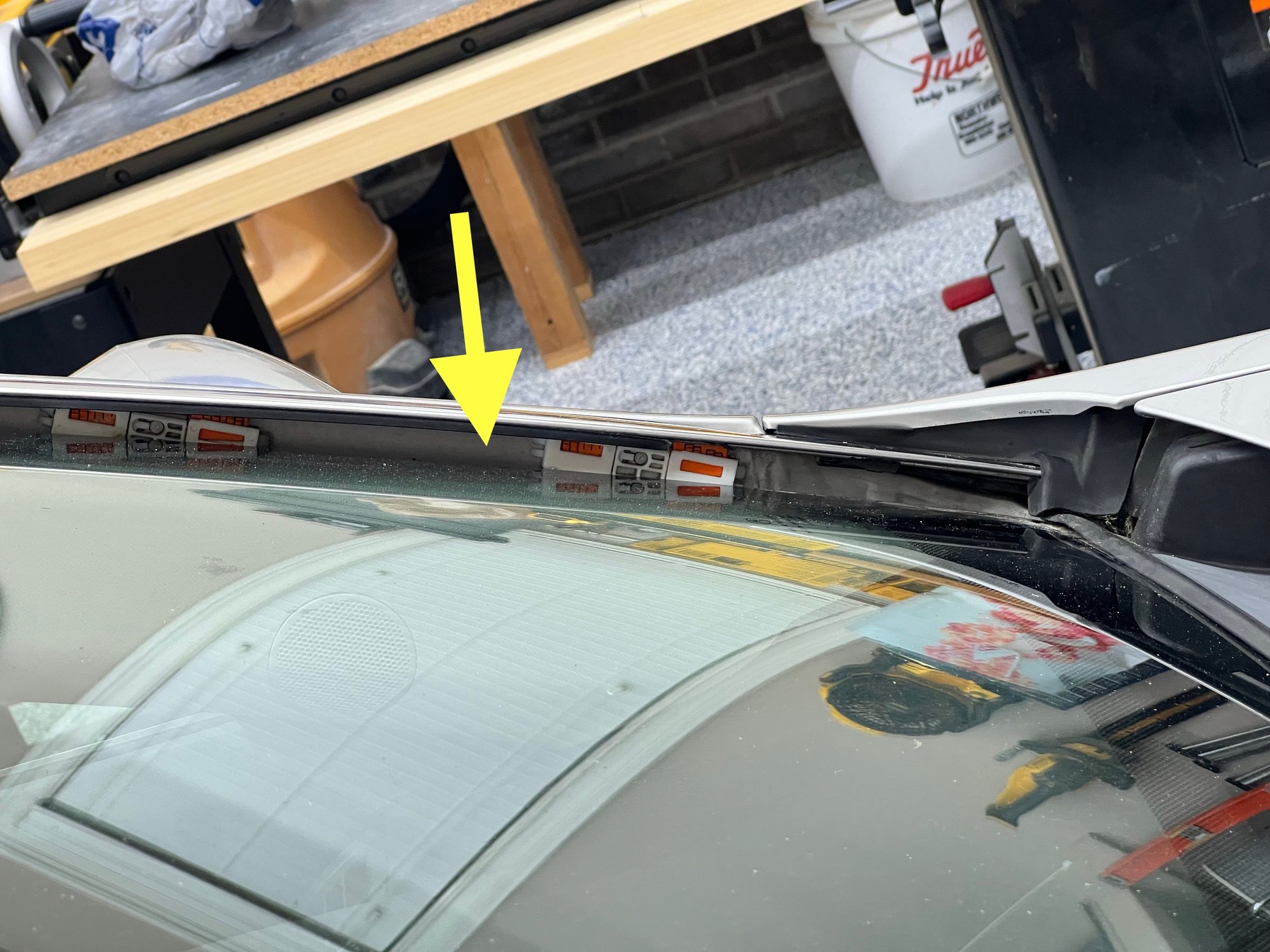 Rubber has disintegrated and been removed, leaving a gap between the chrome drip molding and windshield.