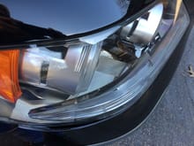 At lower left, you can see the bumper plastic bulging out, evidence that the bottom front of the headlight assembly has been pushed downward and rearward.