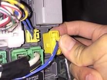 Squeeze then pull off the yellow connector.