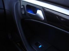 Front passenger door handle recess glows blue.