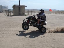 My son Cameron and I at wheelying at White Sands campgroud Little Sahara Ut.                                                                                                                            