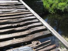 this bridge had broken / missing trusses- it puckers the ass when crossing. It's a good 15' drop to the water.