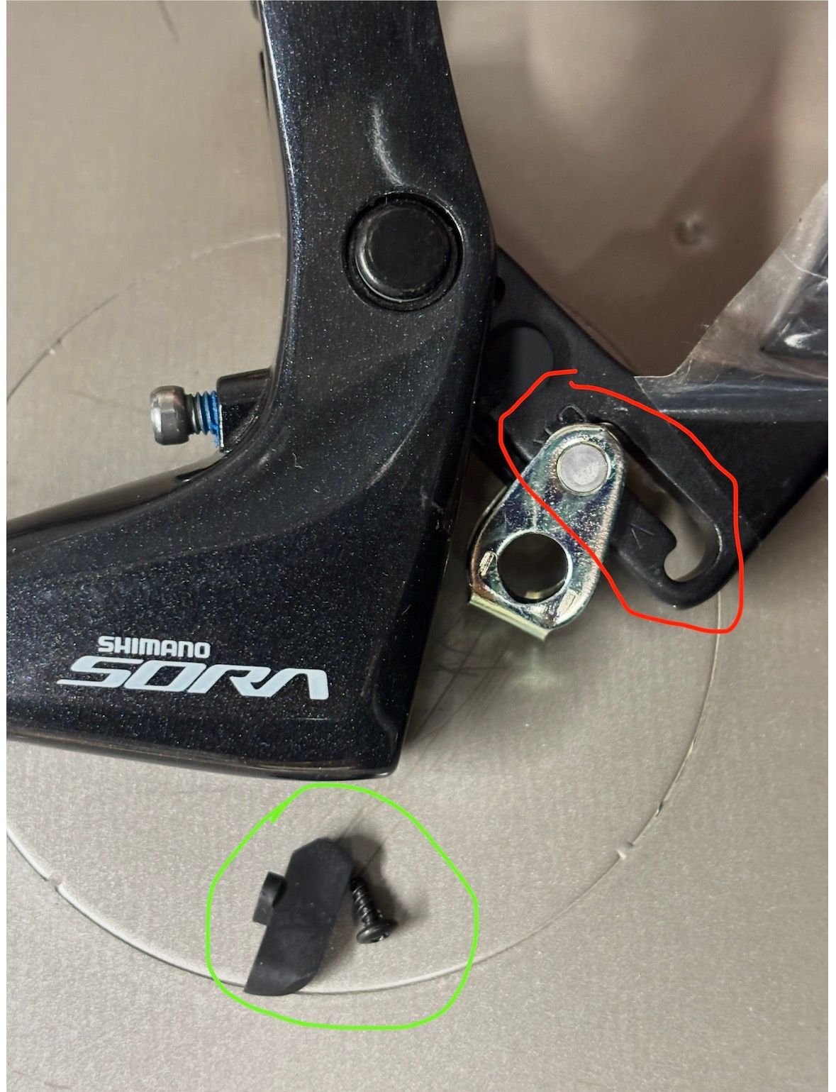 Here is the lever with the piece that allows adjustment removed (circled in green). If the slot (circled in red) is *open*, as shown here, this may be your problem.