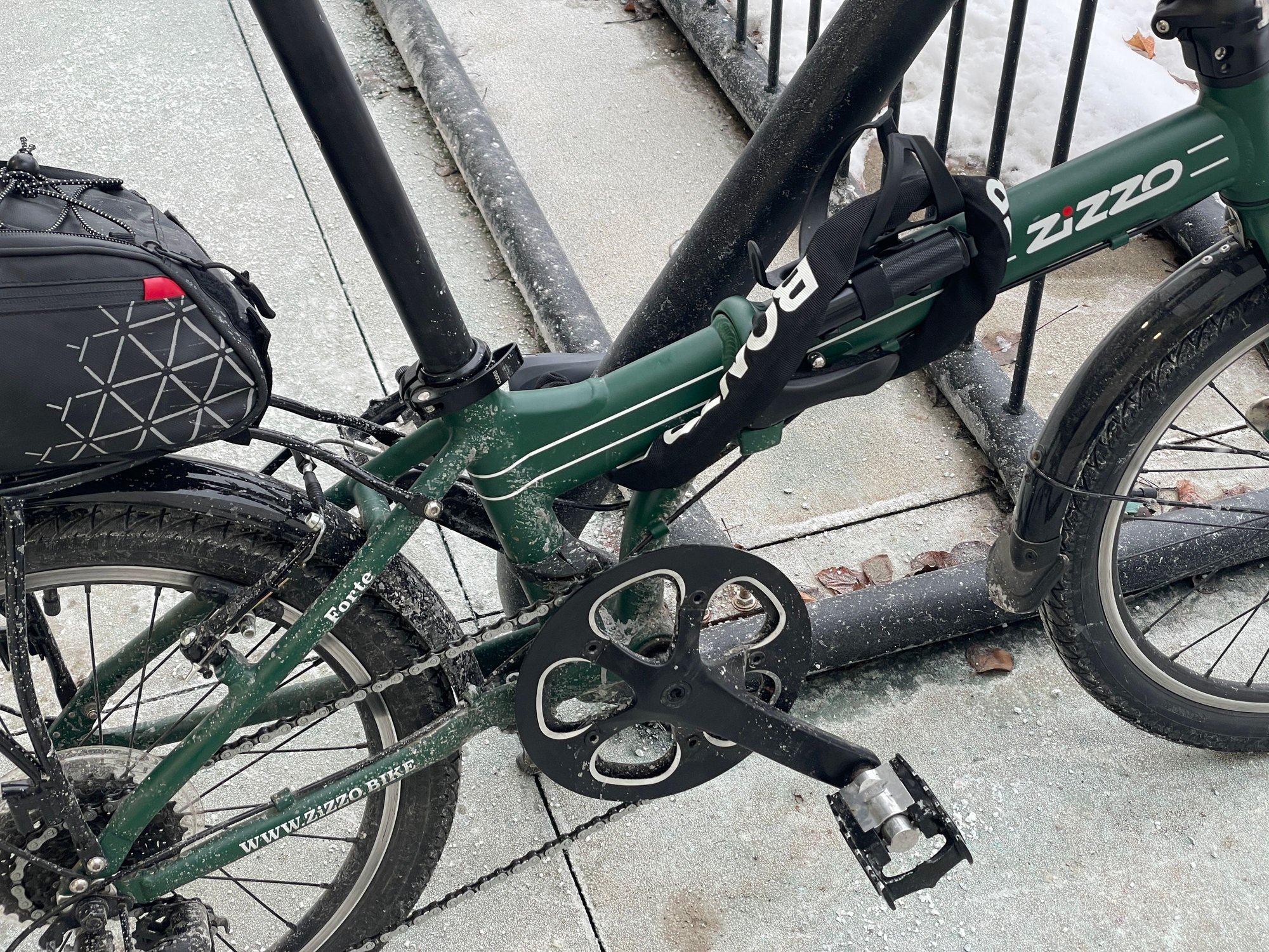 I try to keep the lock away from the chain grease, so it doesn't end up on my clothes. I figured out how to use the bottle cage to route the chain jacket away from the chain.