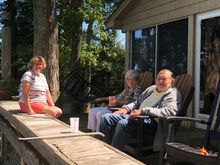 My super sag lady and her parents rocking on their deck watching all the water craft parade by.