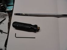 The ground down tip and a 4 head screwdriver body tapped out to hold set screws for two handed operation.