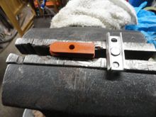 The pad and the holder.  Note the post in the middle of the holder, which prevents the pad from full insertion.