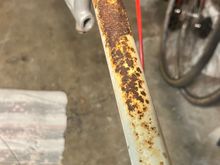 All I did was quickly scrub it with a mildly-soapy brush, and toss it in an oxalic acid bath (sold in many hardware stores as wood bleach, roughly 1 tbs per gallon).