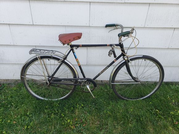 Green grips, cushy "Made in Taiwan" mattress saddle. Original stainless fenders, rubber block pedals, and an old reliable Sturmey Archer AW hub.