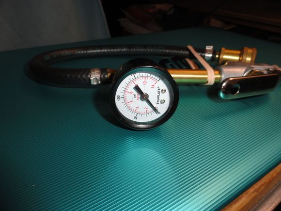 the tool made from a Milton air blow head and modified.  A version one style Silca Presta head. And a hardware store pressure gauge.  The hose is auto fuel line with Pex style fasteners and a brass spud.   