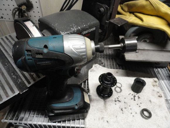 The tool attached to a small battery operated impact driver, that is going to be used to do the work.