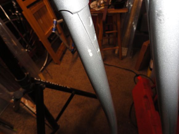 A small ding on the inside of the fork shows a bit of white under the silver, and there is a bit of white on the steerer that appears to have been polished off when the silver was applied.