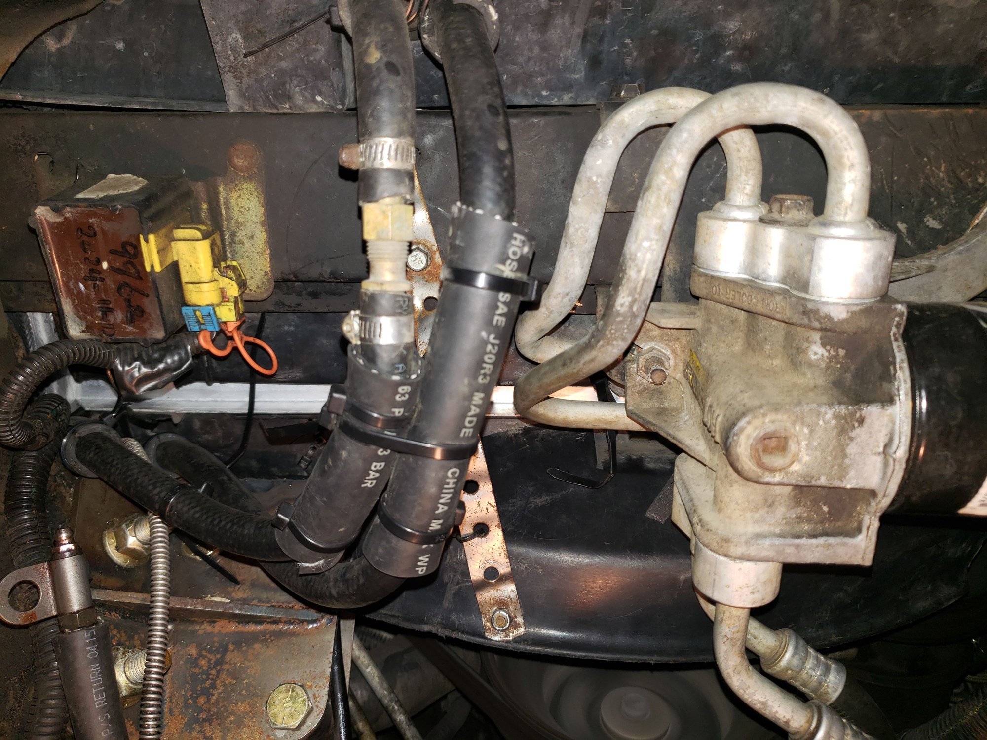 View from below showing my supplemental transmission cooler lines. In the far left of the radiator you can see where I used a zip tie to secure the bottom fan shroud to the bottom of the radiator using a hole in the radiator frame, I did this at the center and on the driver side. too.