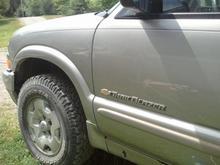 Drivers side door "Trailblazer"   The door badges on this 2001 are different from the black 1999 which has individual letters identical to hatch badge. This badge is identical to 2002   Trailblazers themselves