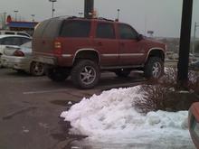 A great lookin lifted Tahoe in the Logan's parking lot.
