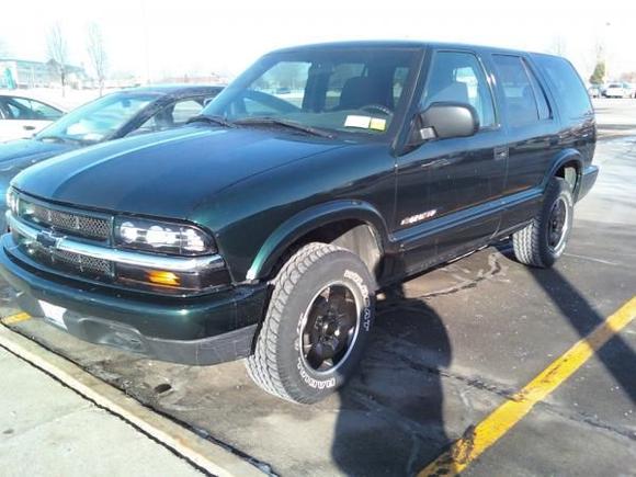 The day after painting the black semi-flat stripes. notice the rims are stock but painted. looks nice enough for me (again i did them right so they are immaculate). in the future some bigger tires with a 2" lift and a little wheel spacing will hurt my turn radius but improve my sway and traction on top of the more aggressive looks