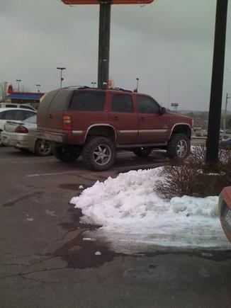 A great lookin lifted Tahoe in the Logan's parking lot.