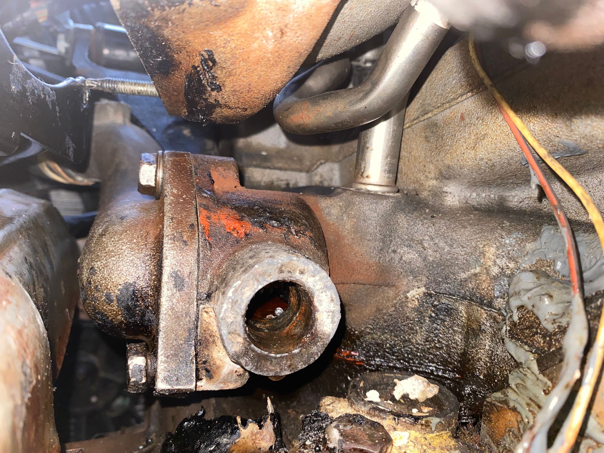 After removing the pipe. In this photo the thermostat housing has been bolted back onto the block. 