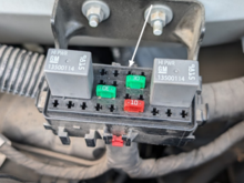 Located above and behind air-filter. 