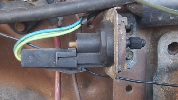 The wires go through the firewall.  One of them terminates in an orange plug, which isn't attached to anything.  The other wire disappears into the inky black darkness behind the steering column.