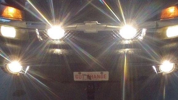 aircraft landing lights  behind grill  they can illuminate a stop sign  for 2 miles