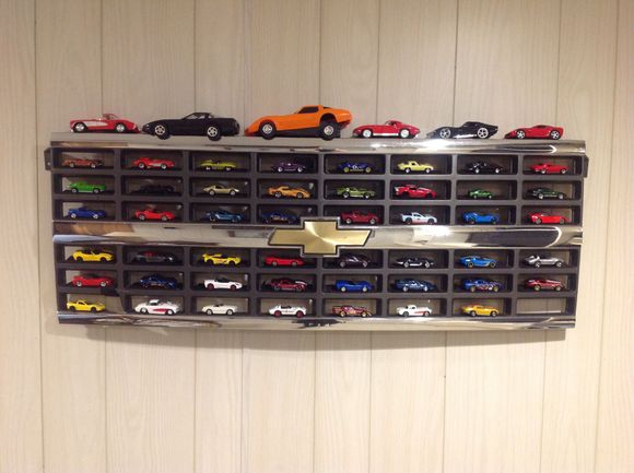 One more to go before it is full.  I used an old pheasant damaged grill from my 1990 full sized Blazer as a shelf for my 1/64 scale model Corvette collection.  I think some of the older model van grills could be used too.