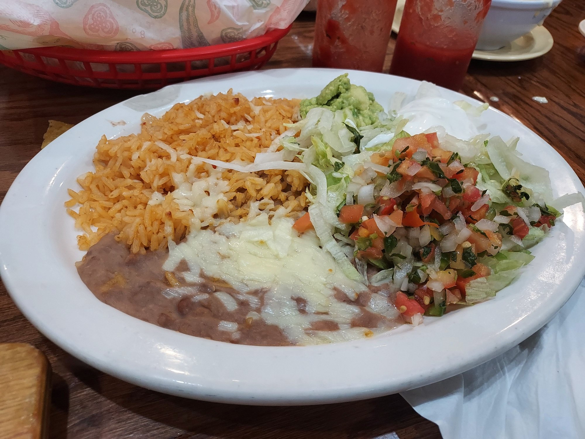 Additional side fixins for Fajitas.  Spanish Rice, Refried Beans, Guacamole, Sour Cream, Lettuce, and Salsa.