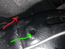 This picture shows the side of the frame.  Does the parking brake cable route where the green arrow is pointed, into the frame and then out the hole shown in the prior picture with the blue arrow.  Finally thru the firewall into the car where the red arrow is pointed. 