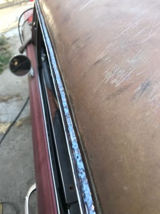 Spot welded in the rain gutters like the factory did