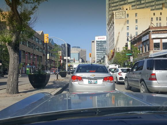 ...stuck in rush hour traffic downtown Winnipeg Manitoba. Ugly and narrow for a wide Classic...