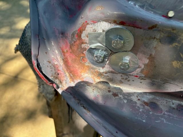 Example of rust that needs removed.  Door hinge nuts are plugged with cap screws and fender washers