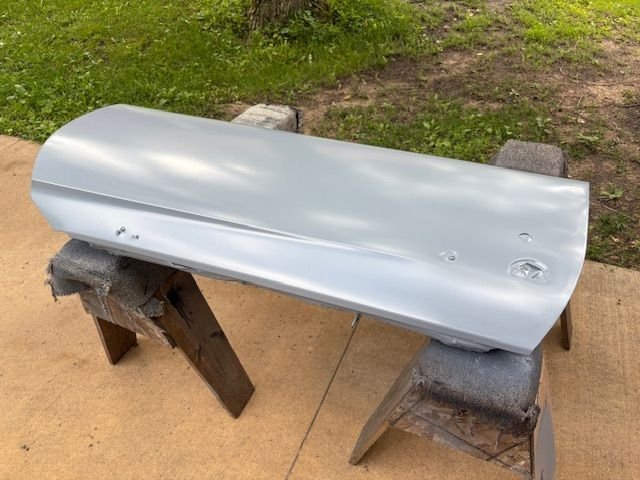 So, the door is now primed, outside face, ends, and bottom.  Blotchy look is sunlight filtering through the oak tree.  Next up is removing old red paint from door sill and hinge jamb area.  And priming those areas.