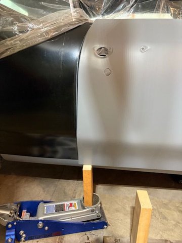 Using small floor jack and. Lock of wood to support rear of door.  Loosened the bottom hinge screws and jacked it up.  Lots of trial and error work involved.  You are in theory adjusting X,Y,and Z axis.  Things are loose goosy.  