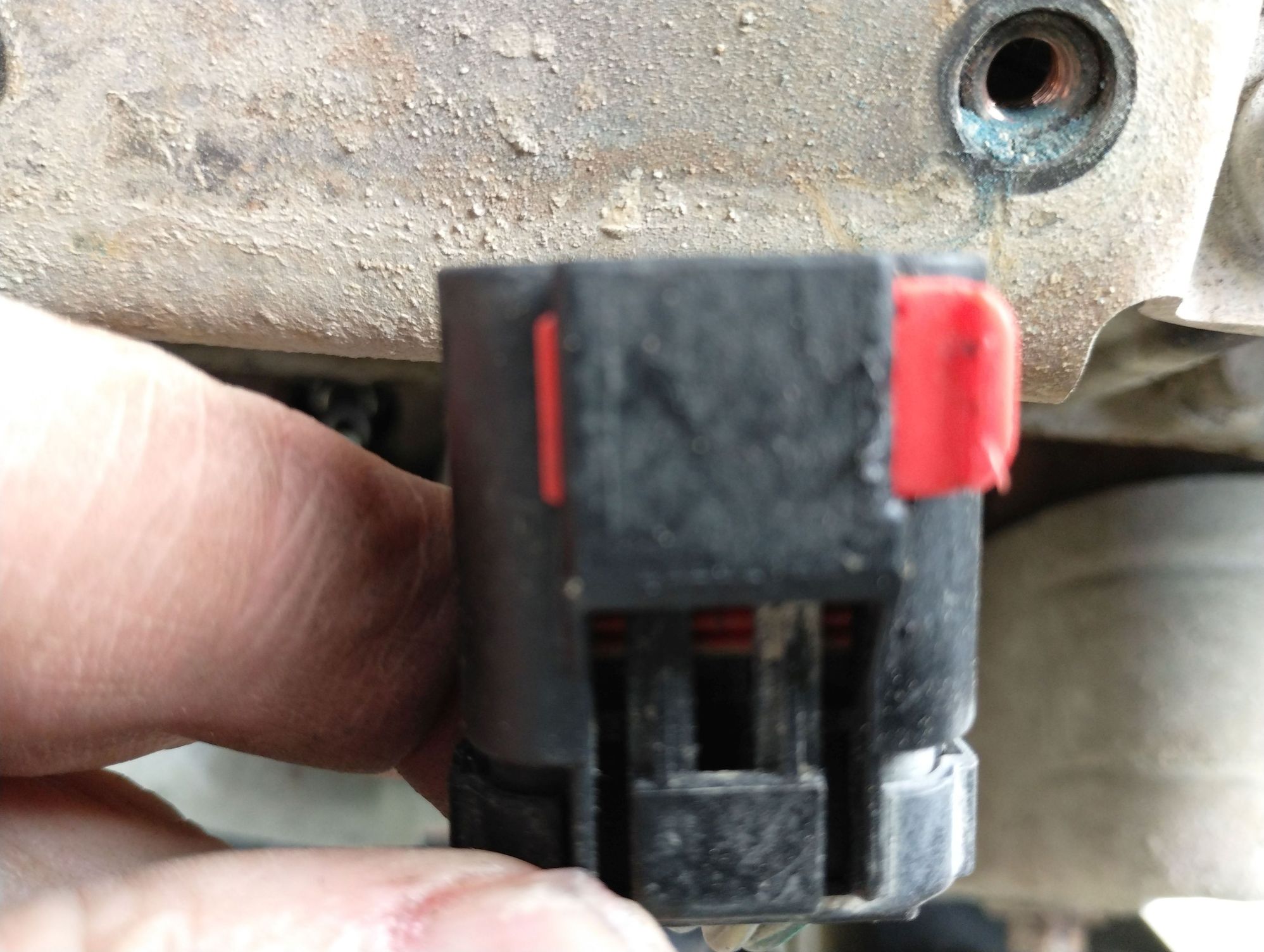 This is what you see of the plug untouched on your V-10 coil pack. You must first push the right hand side over to the left to exposed a small space because your nemesis is waiting for you.