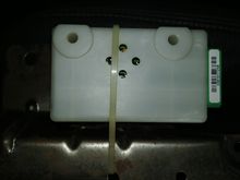 Attached to bottom of center seat