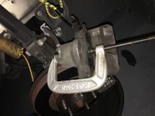 Carefully returning Caliper Piston back.