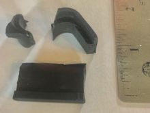 Hard black plastic pieces in pan under the oil pump.