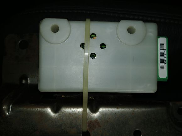 Attached to bottom of center seat