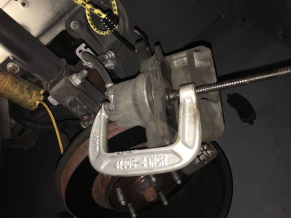 Carefully returning Caliper Piston back.