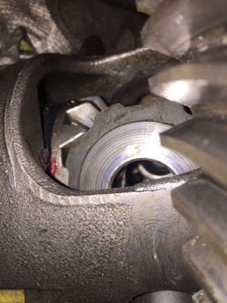 The washer seems like it should match up to the chamfer on the gear