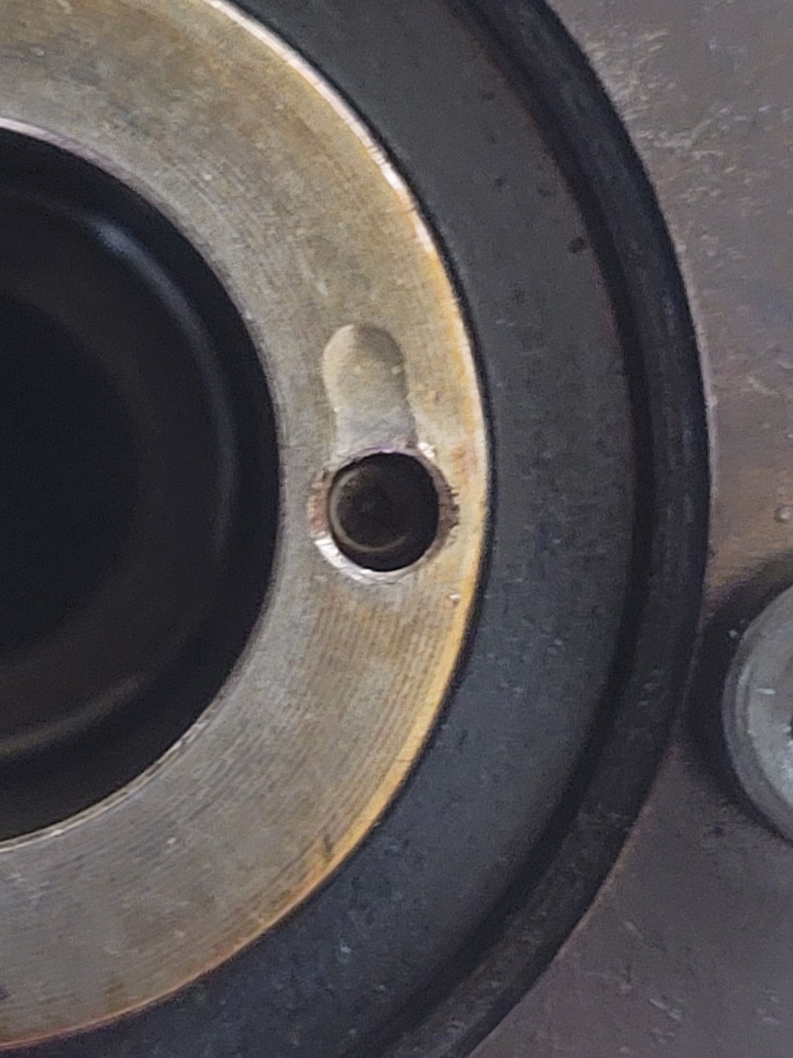 Intake Cam Sprocket. Dowel pin has a tiny bit of play, fits kinda snug, but i can pull it out with my fingers. Looks like a mark from the dowel pin above it. 