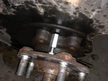 Place the hanger nut and bolt between the wheel bearing. 1 above and 1 below the wheel bearing so you can press out the bearing evenly. 