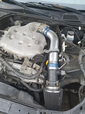 The stock intake was dry rotted when i got it, so i replaced it with a garbage tube i found on ebay. The filter it came with ended up falling apart, so i got this one from autozone. Yes, that is a hurricane strap holding the tube in place. Lots of ghetto work done, but ive done it all myself (with help of some friends). 