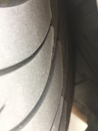 Shot of the rear side of the tire, outer edge. Looks like the trailing edges of the tread are lifted up.