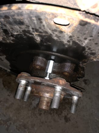 Place the hanger nut and bolt between the wheel bearing. 1 above and 1 below the wheel bearing so you can press out the bearing evenly. 