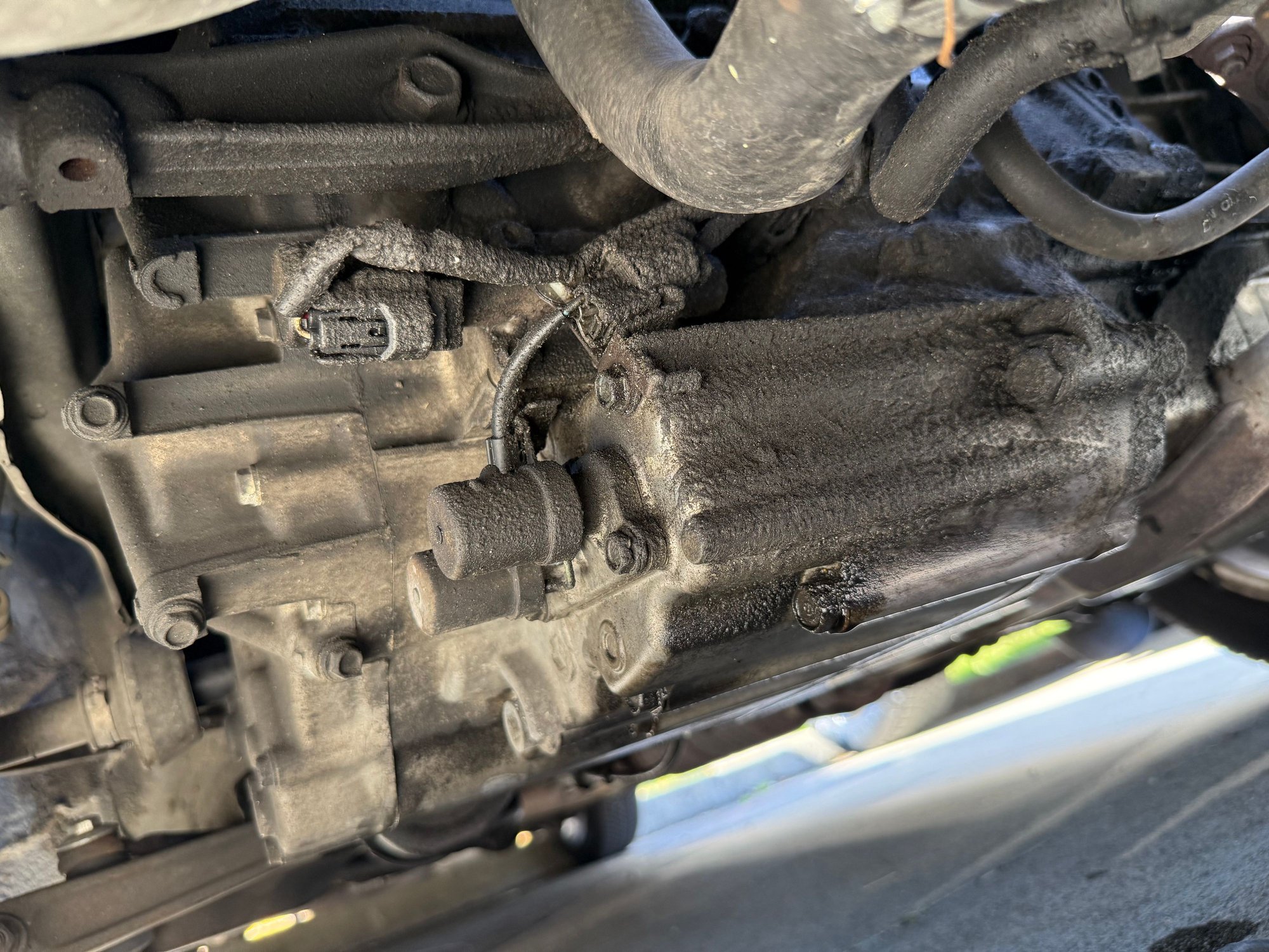 This is what my A/B shift solenoids looked like before I cleaned them a bit, haven�t taken this one off yet but I plan on doing that when I do my next drain and fill, but I cannot for the life of my get that connector disconnected. I had coolant leaking from my heater core hose which I replaced, as well as my old rad. One of the transmission cooler lines going into the rad, was very dirty with that same gunk on the tranny, the other was super clean. ATF only had shimmer in it, otherwise fine.