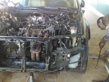 1st day work. 
We already removed headers and harness from the engine. Also unbolted the flywheel bolts under the car to allow for seperation of the motor and transmission.